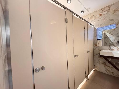 a bathroom with a shower and a sink at Hostel Republic at Galle Face in Colombo