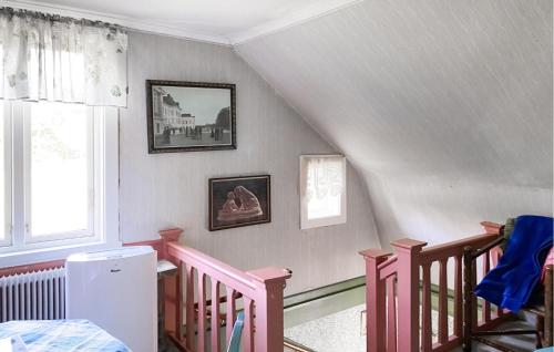 a attic room with a staircase and a window at 2 Bedroom Cozy Home In Skruv in Skruv