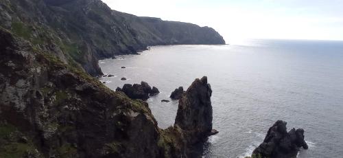 an aerial view of a rocky coast with the ocean at Paraíso Ortegal in Feás