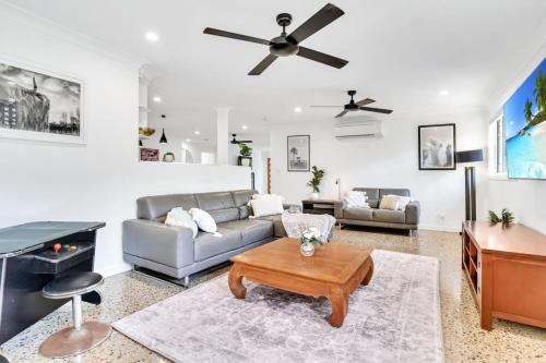a living room with a couch and a table at The Residence- Rainforest Retreat in Stratford