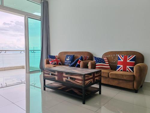 a living room with a couch and a coffee table at Invincible Seaview Vacation Condo 3R3B 8Pax in Bayan Lepas