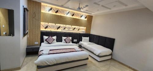 a hotel room with two beds in a bedroom at Hotel Varanasi Heritage in Varanasi