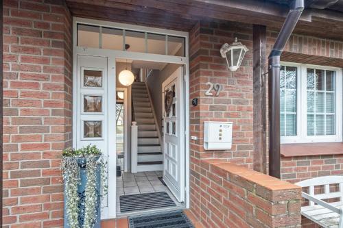 a brick house with a white door and window at Cosy Apartment In Soltau in Soltau