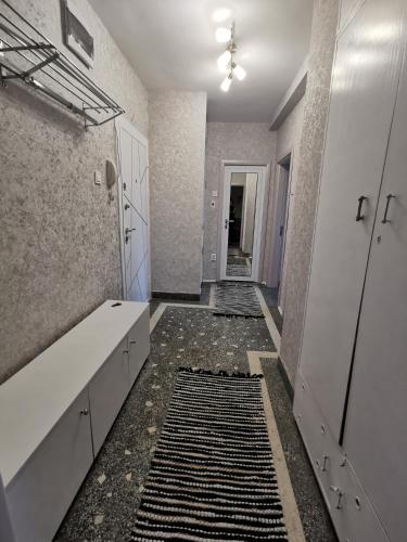 a bathroom with a rug on the floor at Апартамент Център in Vratsa