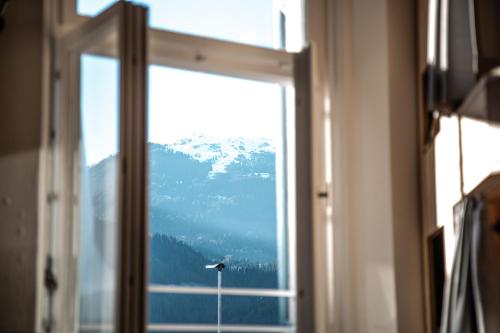 a window with a view of a mountain at St Josefsheim Hostel in Schruns-Tschagguns