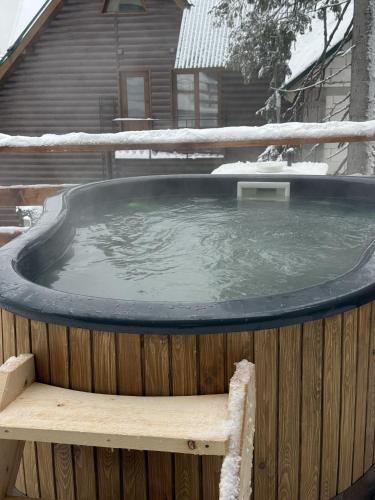 a hot tub with snow on top of a wooden fence at Маріна Драгобрат in Dragobrat