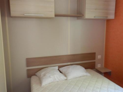 - 2 oreillers blancs assis sur un lit dans la chambre dans l'établissement Camping domaine Saint Martin 4 étoiles, à Casteil