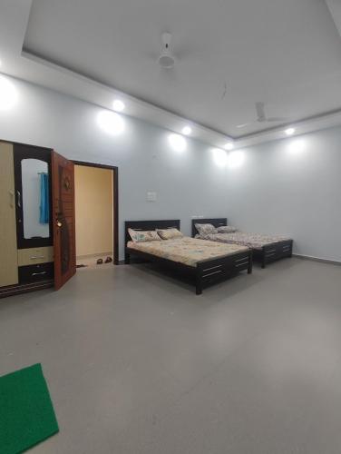 a room with two beds and a mirror at RK mahal & residency in Dindigul