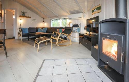a living room with a fireplace and a couch at Klitbo in Rømø