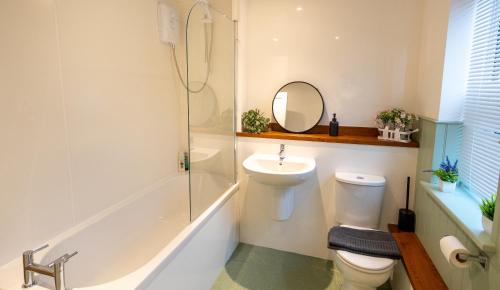 a bathroom with a sink and a toilet and a shower at Stylish Gateway-2 bedroom house -5 minutes from the beach in Eastbourne