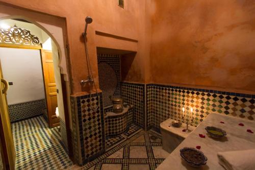 a bathroom with a sink and a toilet in a room at Riad - Dar Al Andalous in Fès
