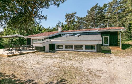 a house with a large yard in front of it at Amazing Home In Nexø With Sauna in Snogebæk