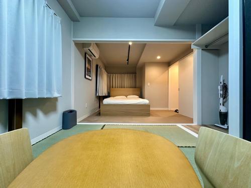 a bedroom with a bed in the middle of a room at LoveAsakusaBigSpaceModernHome 浅草寺6分 浅草寺駅10分 2-8人 成田&羽田空港直通 in Tokyo