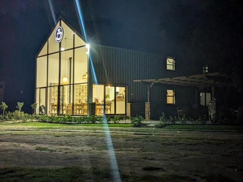 a building with a light on the front at night at Diamantvallei Landgoed in Rayton