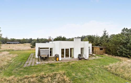 a white house in the middle of a field at 3 Bedroom Gorgeous Home In Ålbæk in Ålbæk