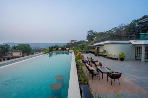 a view of the pool at a resort at ELIVAAS 1 BHK with Rooftop Pool - Kamerios Verano in Goa