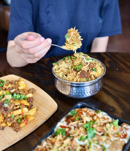 a person is eating food from a table with plates of food at Abbey Hotel in Leicester
