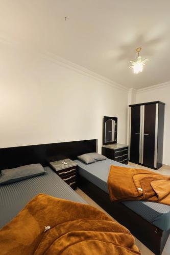 a bedroom with two beds and a tv in it at Lucky palace Dahab in Dahab