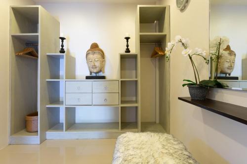 a room with shelves with heads on the wall at Baan Lily in Chaweng