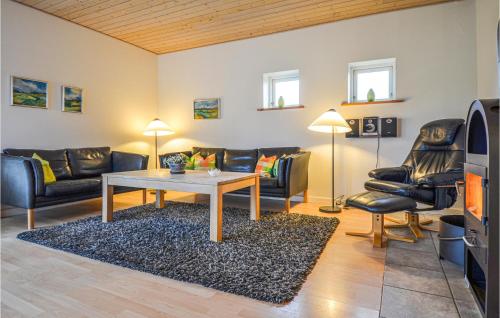 a living room with a couch and a table at Holiday Home Ravnsvej Ebeltoft Denm in Ebeltoft