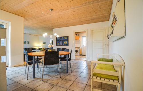 a dining room and living room with a table and chairs at Holiday Home Ravnsvej Ebeltoft Denm in Ebeltoft