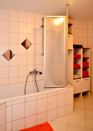a bathroom with a shower and a tub at FeWo - "Am Schwedenstein" 85qm - bis 5 Personen in Ohorn