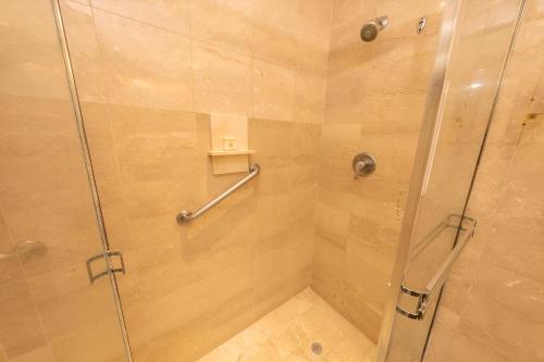 a bathroom with a shower with a glass door at Hotel El Panama by Faranda Grand, a member of Radisson Individuals in Panama City