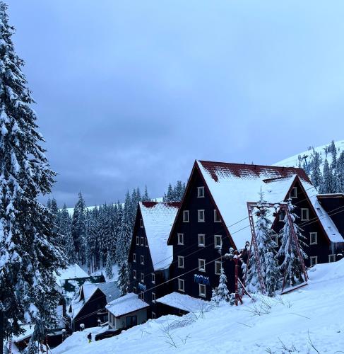 a large black barn with snow on it at Маріна Драгобрат in Dragobrat