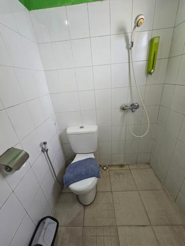 a small bathroom with a toilet and a shower at Kusma Hotel Bandungan Semarang in Semarang