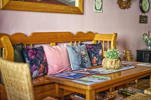 a table with a couch with pillows on it at Penzion Vinařství Červinka in Horní Věstonice