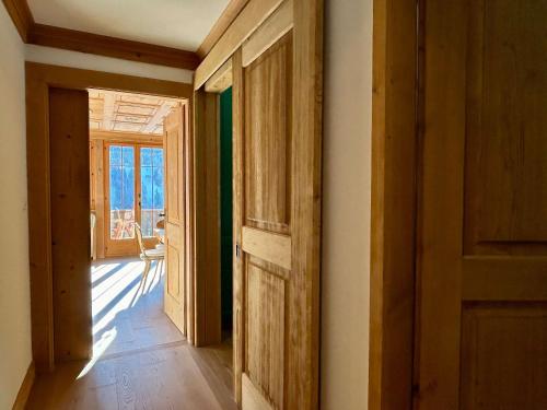 an open door in a room with a hallway at Beautiful Flat With Traditional Architecture in Rougemont