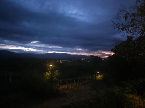a night view of a field with a street light at Black Sheep House Khaoyai by ALPHATEL PARTNER in Pong Talong