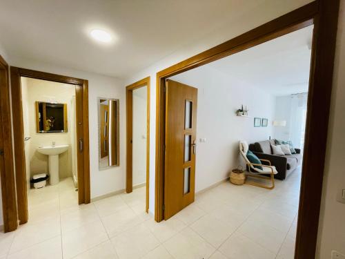a living room with a door open and a couch at Jardines de Veneciola by Alina365 in La Manga del Mar Menor