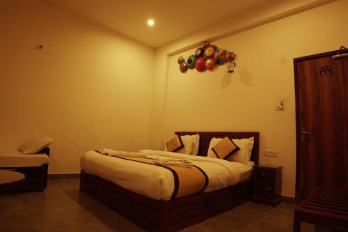 a bedroom with a bed with a balloon on the wall at Golden Bird Pushkar in Pushkar