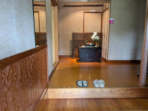 a pair of shoes sitting on the floor of a hallway at 縁の宿 北堀 in Matsue