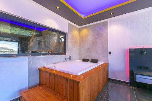 a bathroom with a bath tub with a purple ceiling at Villa Yeşim in Kas