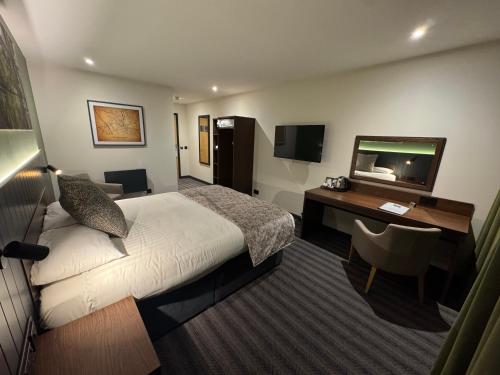 a hotel room with a bed and a desk at Hotel Nineteen in Barnsley