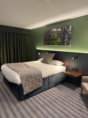 a hotel room with a bed and a chair at Hotel Nineteen in Barnsley