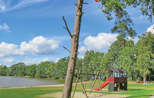 a playground in a park next to a tree at Awesome Home In Bromölla With Wifi in Bromölla