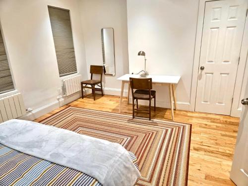 a bedroom with a bed and a table and chairs at Jersey City Private Entire Apartment - 30 Minutes From Wall St New York City in Jersey City