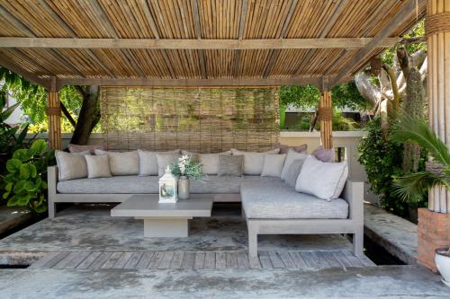 a patio with a couch and a table at Baan Lily in Chaweng