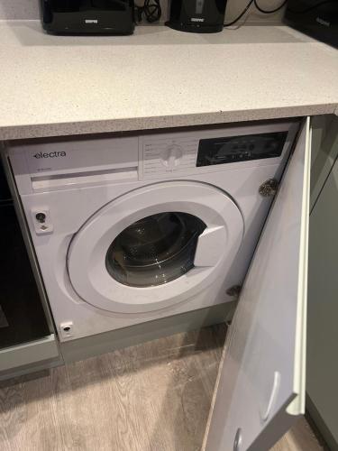 a washing machine in a kitchen under a counter at Church Mews Central Townhouse West Hoe Plymouth in Plymouth