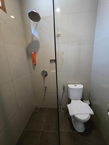 a bathroom with a toilet and a shower stall at Kusma Hotel Bandungan Semarang in Semarang