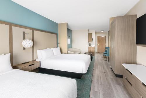 a hotel room with two beds and a desk at Fairfield by Marriott Inn & Suites Marathon Florida Keys in Marathon
