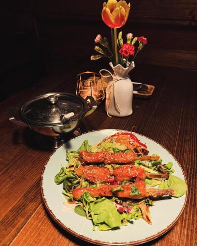a plate of food on a table with a salad at Zlatý Klas in Mariánské Lázně