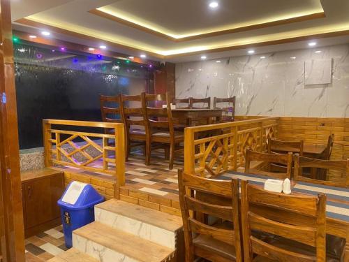 a dining room with wooden chairs and a table at Hotel Middle Temple Pvt Ltd in Kathmandu