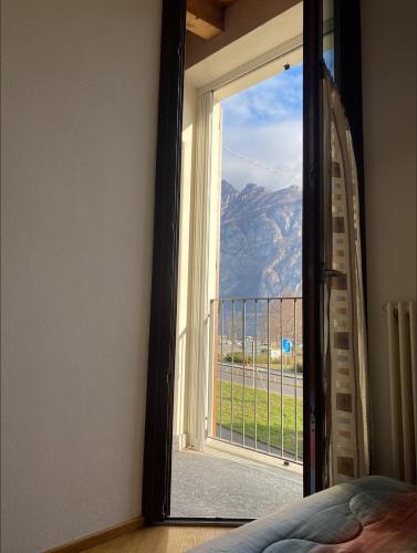 a bedroom door with a view of a mountain at COZY LAKE COMO APARTMENTS in Valmadrera