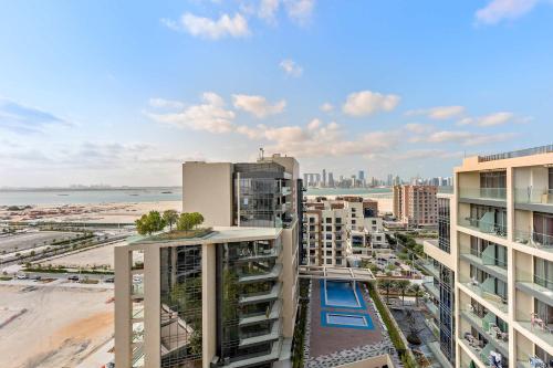 an aerial view of a city with buildings and a beach at Silkhaus Premium 1BR at Soho Square in Saadiyat in Abu Dhabi