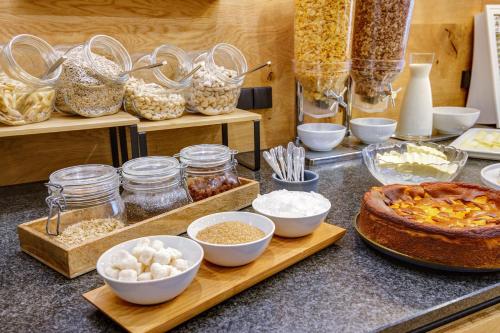 a counter topped with bowls of food and other ingredients at Smarthotel Schmid in Sitzenberg
