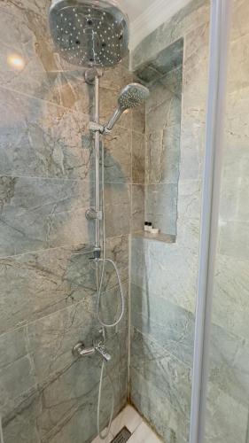 a shower with a shower head in a bathroom at La Mer Old City Hotel in Istanbul